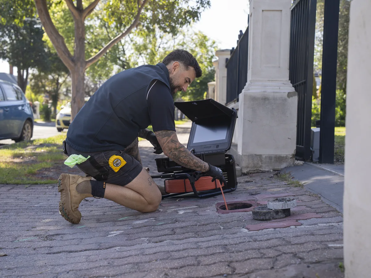 Plumber operating CCTV drain inspection equipment
