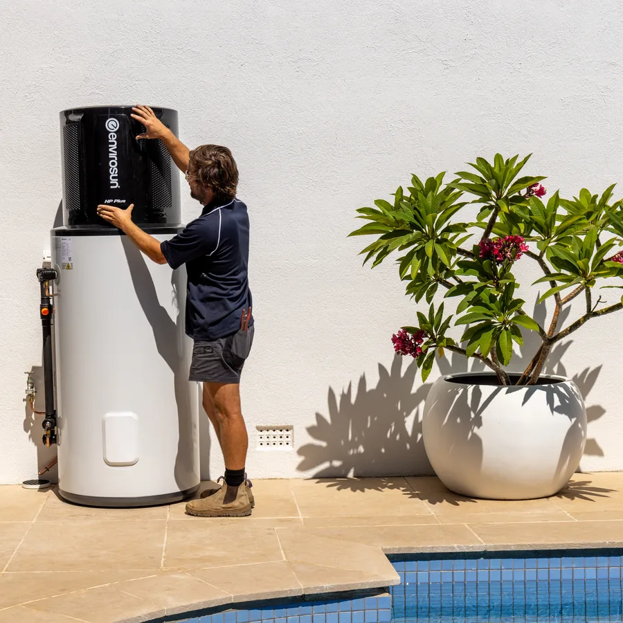 Hall & Baum plumber servicing a heat pump hot water system