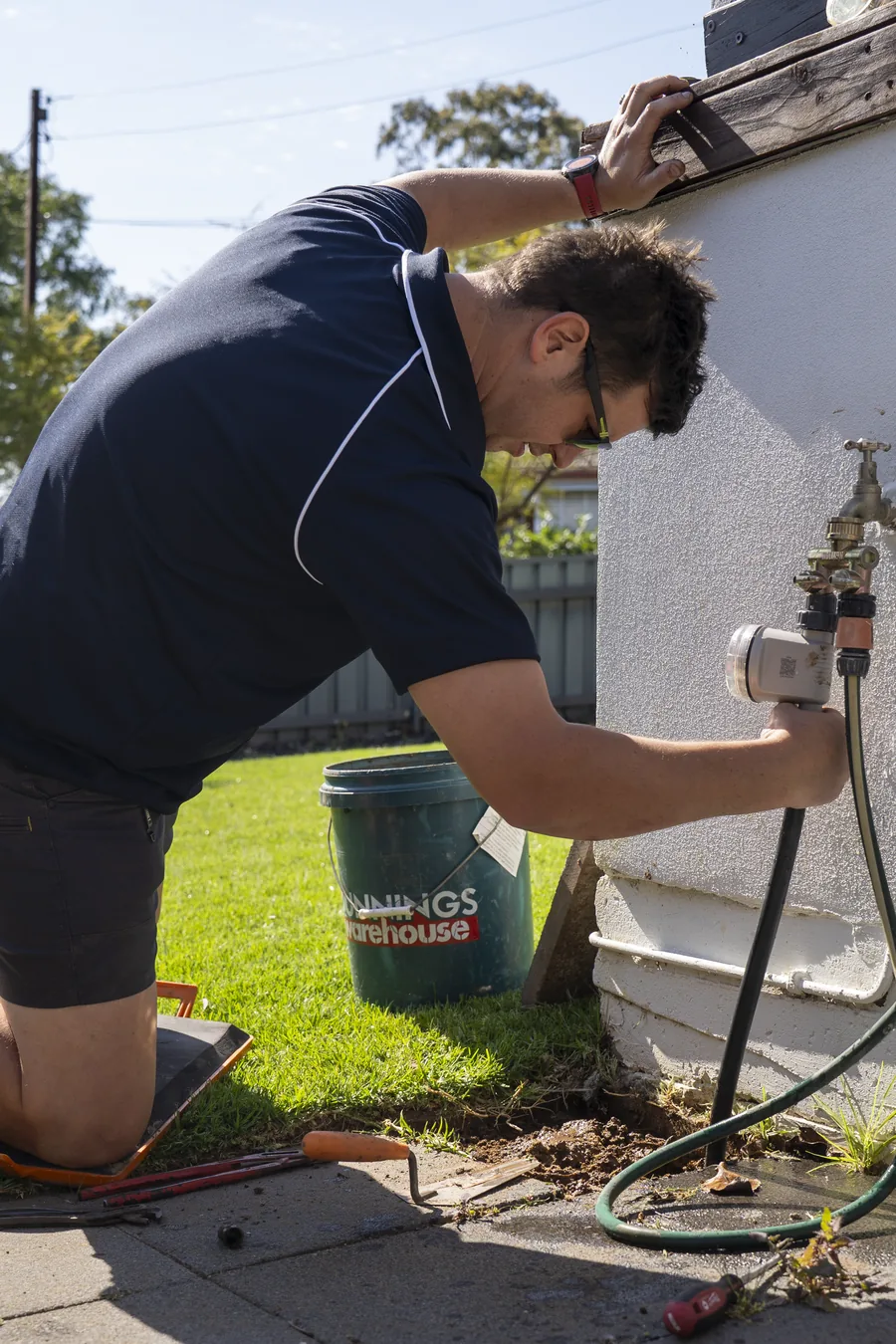 Hall & Baum plumber repairing an outdoor tap