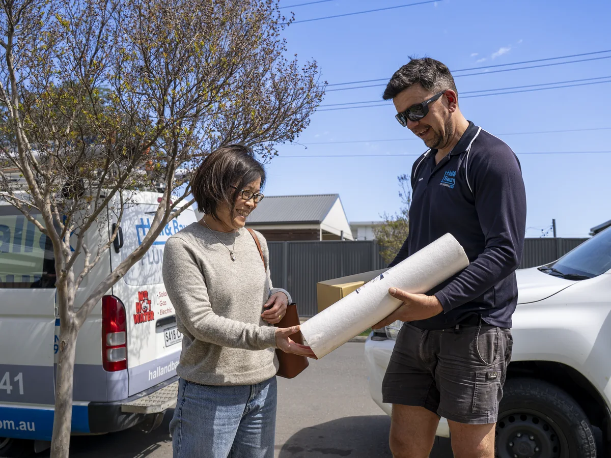 Hall & Baum plumber discussing plumbing work with a customer