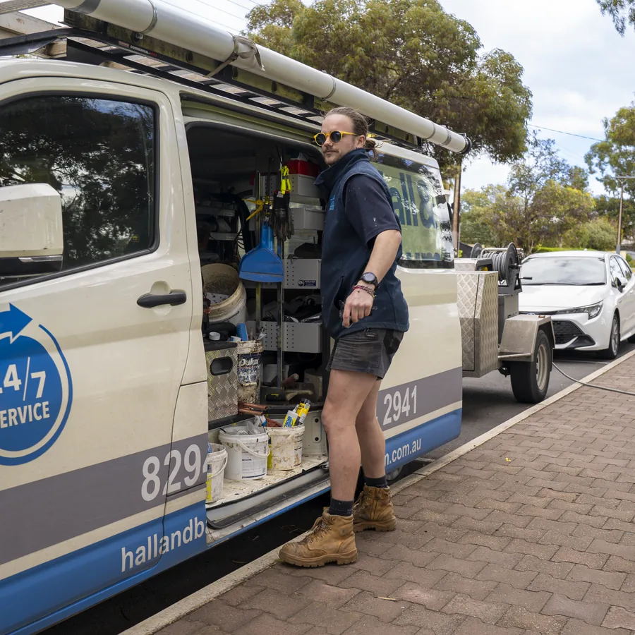 Hall & Baum plumber beside a fully equipped service van
