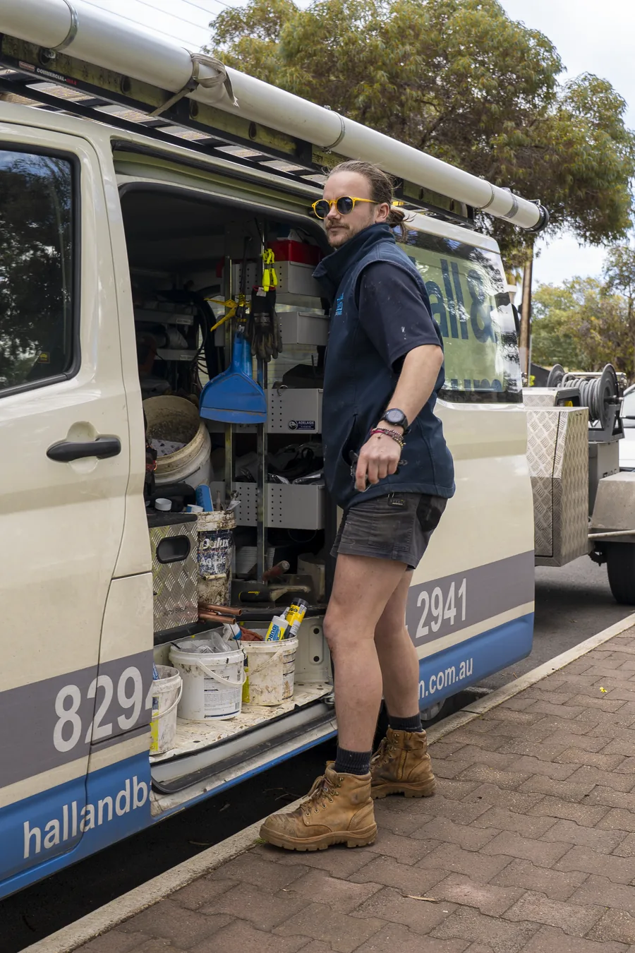 Hall & Baum plumber beside a fully equipped service van