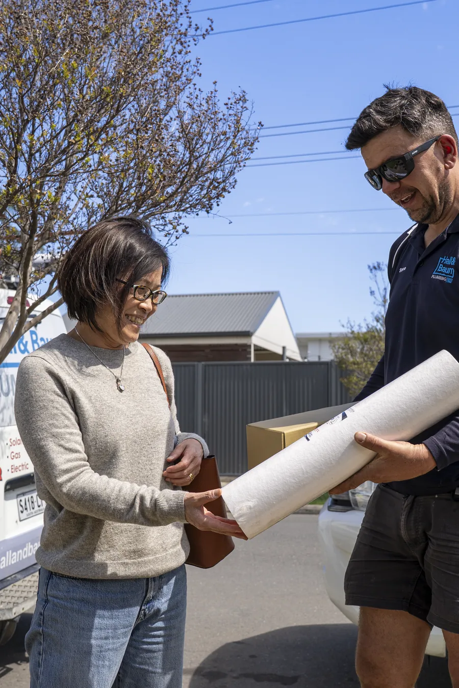 Hall & Baum plumber discussing plumbing plans with a homeowner